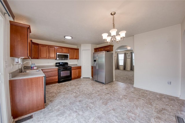 204 Ascot Ct, Moon/Crescent Twp, PA 15108 - kitchen featuring stainless steel appliances, visible vents, a sink, arched walkways, and light countertops
