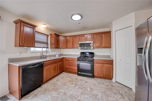 204 Ascot Ct, Moon/Crescent Twp, PA 15108 - kitchen with a sink, light countertops, black appliances, and brown cabinets