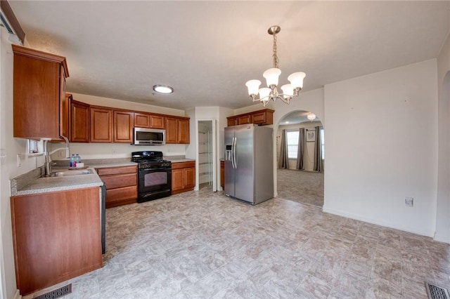 204 Ascot Ct, Moon/Crescent Twp, PA 15108 - kitchen featuring a sink, visible vents, arched walkways, light countertops, and appliances with stainless steel finishes