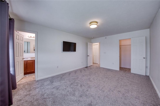 204 Ascot Ct, Moon/Crescent Twp, PA 15108 - unfurnished bedroom with ensuite bathroom, a closet, light carpet, a walk in closet, and baseboards