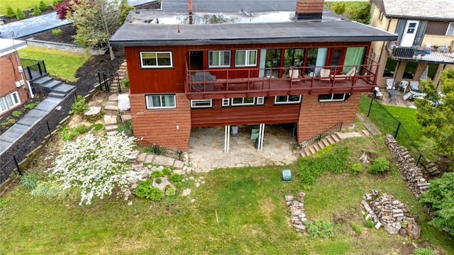1898 Brushcliff Rd, Churchill Boro, PA 15221 - back of property featuring a lawn, stairs, and a deck