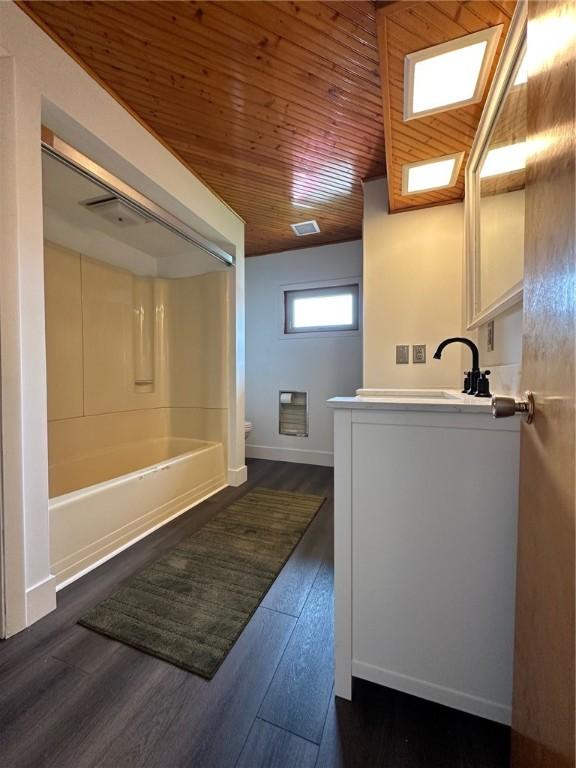 full bath with toilet, visible vents, wood ceiling, vanity, and wood finished floors