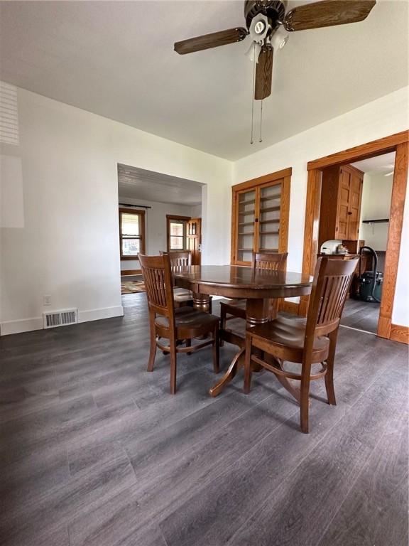 dining area with ceiling fan, baseboards, visible vents, and wood finished floors