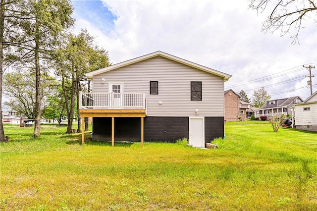back of house with a yard and a deck