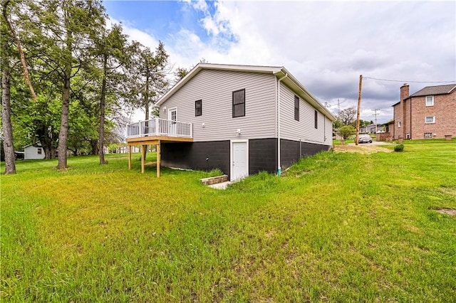 back of house with a yard and a wooden deck