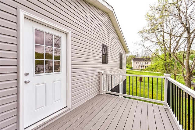 wooden deck with a lawn