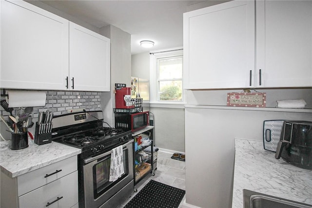 2805 Louisiana Ave, Dormont, PA 15216 - kitchen featuring gas range, tasteful backsplash, white cabinetry, and light stone countertops