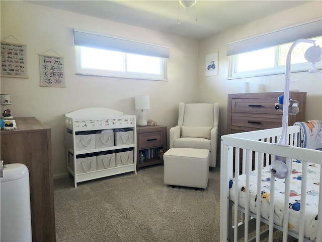 carpeted bedroom featuring a crib