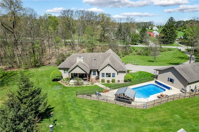 view of swimming pool with a yard, a patio, a fenced in pool, and a fenced backyard