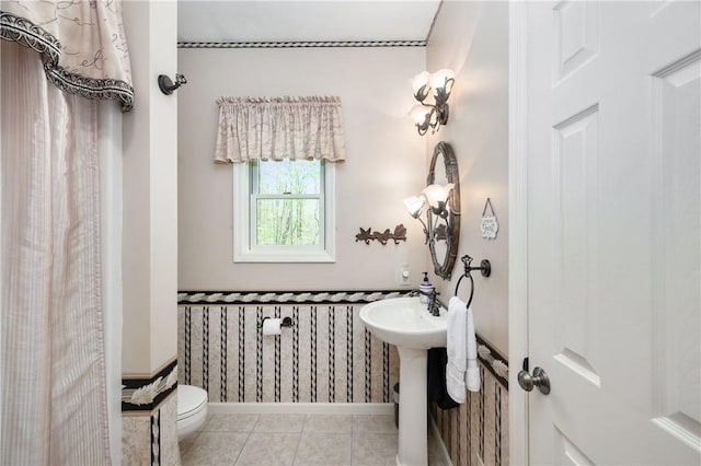 bathroom featuring toilet and tile patterned flooring