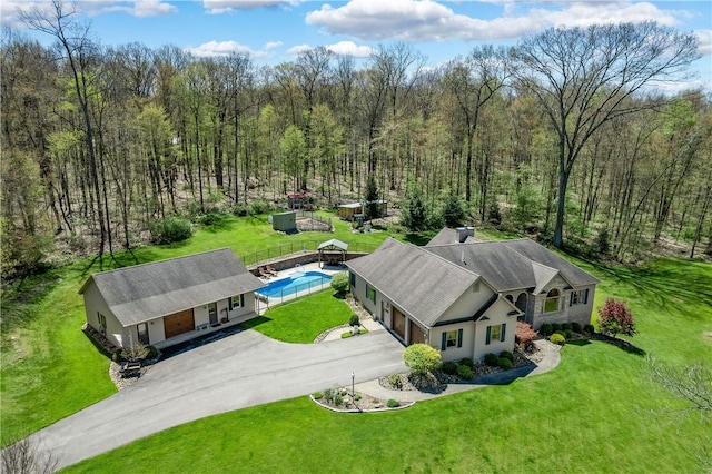 birds eye view of property featuring a view of trees