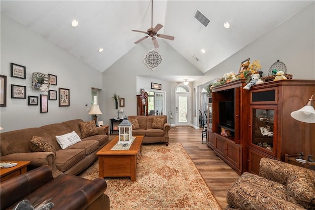living area with a ceiling fan, recessed lighting, visible vents, high vaulted ceiling, and wood finished floors