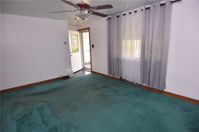 carpeted empty room featuring baseboards and ceiling fan