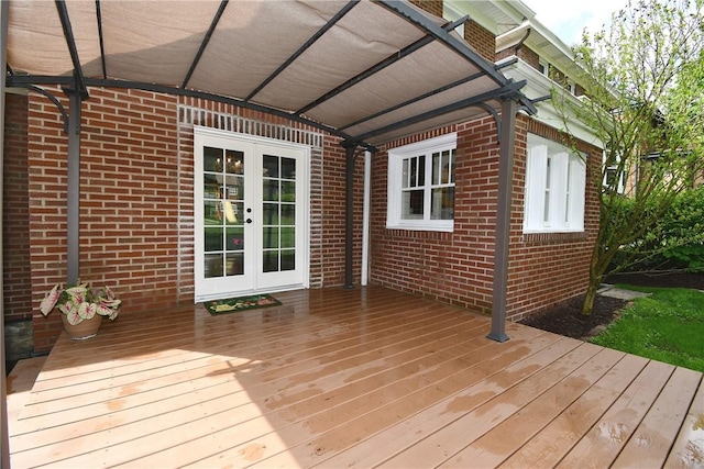 wooden terrace with a pergola and french doors