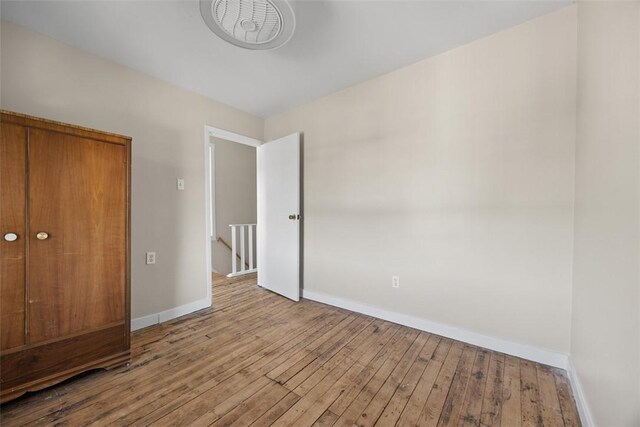 5611 Wickliff St, Lawrenceville, PA 15201 - unfurnished bedroom with baseboards and hardwood / wood-style floors