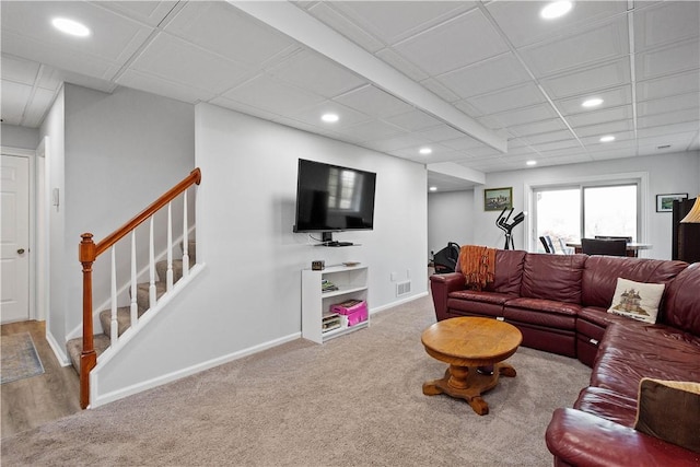 carpeted living area featuring baseboards, stairway, visible vents, and recessed lighting
