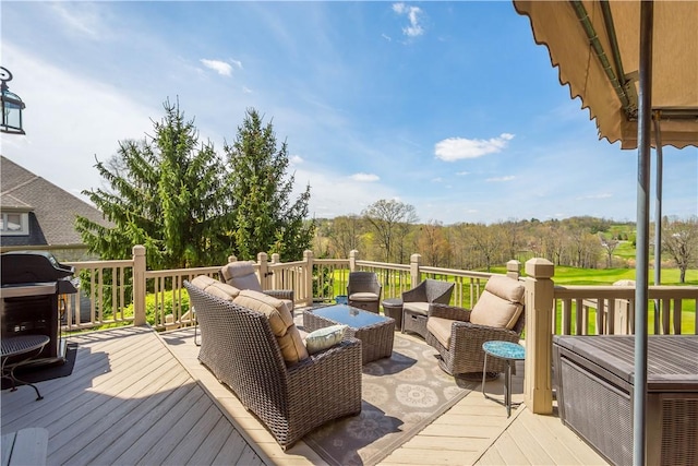 wooden deck with grilling area and an outdoor hangout area