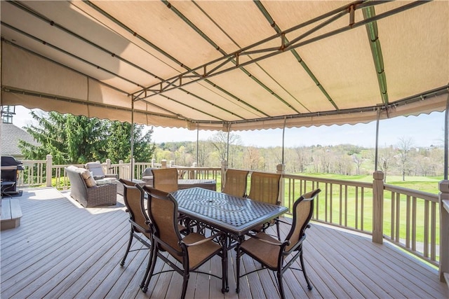 wooden deck with grilling area and outdoor dining space