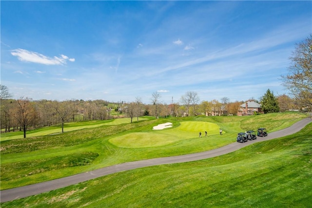 surrounding community featuring a yard and view of golf course