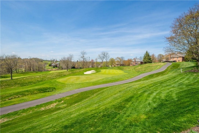 view of home's community featuring a yard and golf course view