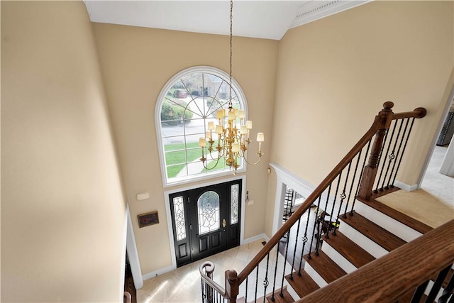 foyer featuring an inviting chandelier, a high ceiling, carpet floors, stairway, and baseboards