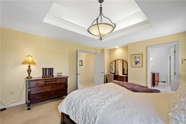 bedroom featuring baseboards, a tray ceiling, visible vents, and light colored carpet