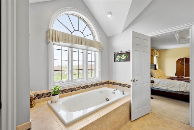 ensuite bathroom with tile patterned floors, ensuite bath, vaulted ceiling, and a jetted tub