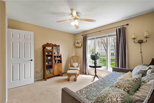 bedroom with baseboards, light carpet, and ceiling fan