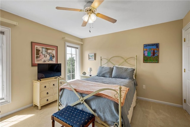 bedroom featuring baseboards, a ceiling fan, and light colored carpet