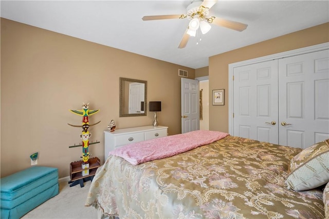 bedroom featuring carpet flooring, a closet, visible vents, and a ceiling fan