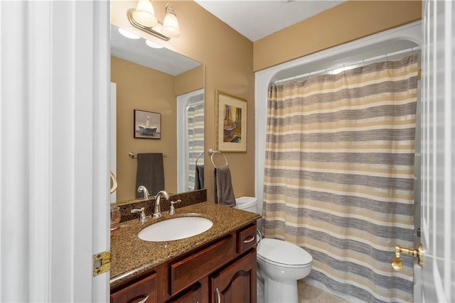 bathroom featuring toilet, curtained shower, and vanity