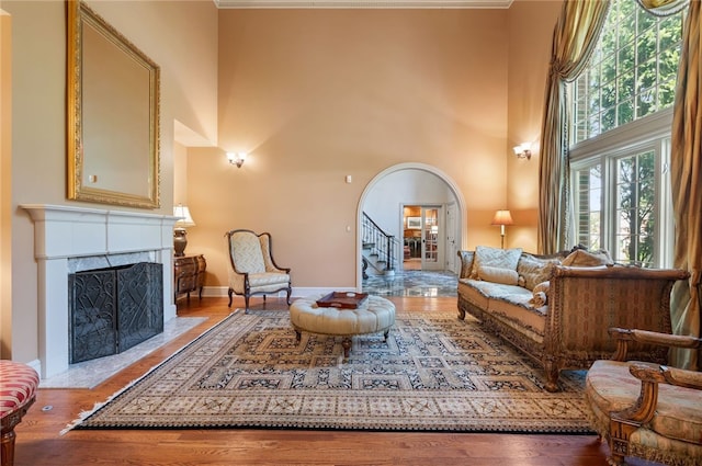1609 Blackburn Heights Dr, Franklin Park, PA 15143 - sitting room featuring wood finished floors, arched walkways, a fireplace with flush hearth, and stairs