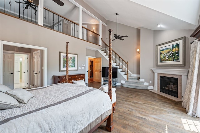 1609 Blackburn Heights Dr, Franklin Park, PA 15143 - bedroom featuring baseboards, a tile fireplace, high vaulted ceiling, and wood finished floors