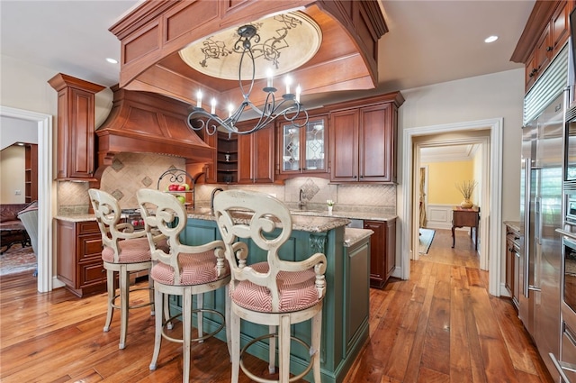 1609 Blackburn Heights Dr, Franklin Park, PA 15143 - kitchen featuring a kitchen island, light wood-style floors, a chandelier, and light stone counters