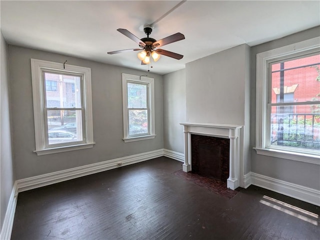 2345 Perrysville Ave, Perry Hilltop, PA 15214 - unfurnished living room featuring plenty of natural light, baseboards, a fireplace with flush hearth, and dark wood-style floors