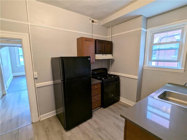 2345 Perrysville Ave, Perry Hilltop, PA 15214 - kitchen featuring black appliances, light wood finished floors, a sink, and under cabinet range hood
