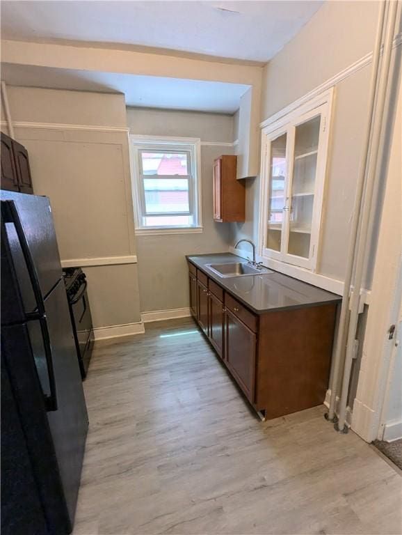 2345 Perrysville Ave, Perry Hilltop, PA 15214 - kitchen featuring light wood-style flooring, a sink, dark countertops, baseboards, and black appliances