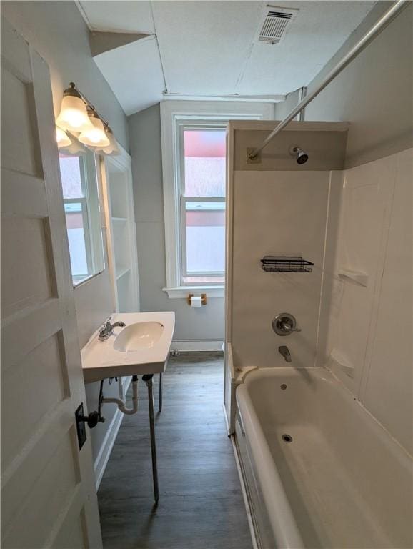 2345 Perrysville Ave, Perry Hilltop, PA 15214 - bathroom featuring visible vents, wood finished floors, a healthy amount of sunlight, and shower / bathtub combination