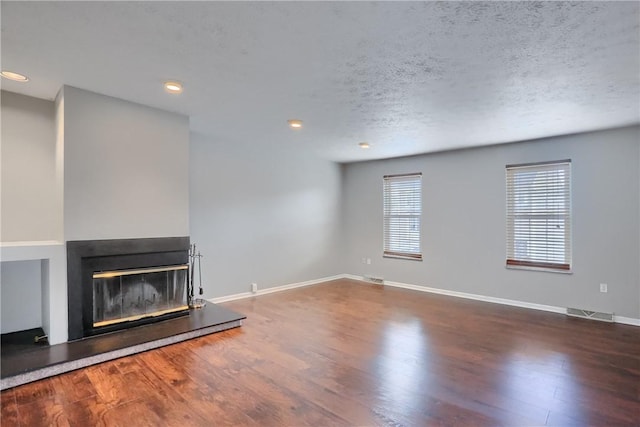 2748 Hunters Point Dr, Franklin Park, PA 15090 - unfurnished living room featuring recessed lighting, baseboards, a glass covered fireplace, and wood finished floors