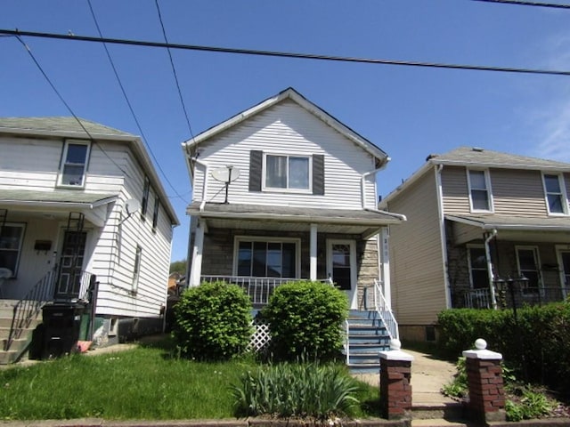 view of front of home featuring a porch and stairway