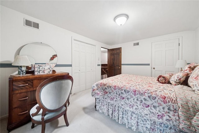 carpeted bedroom featuring a closet and visible vents