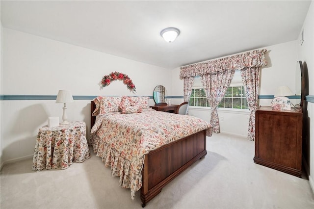 bedroom featuring light carpet, baseboards, and visible vents