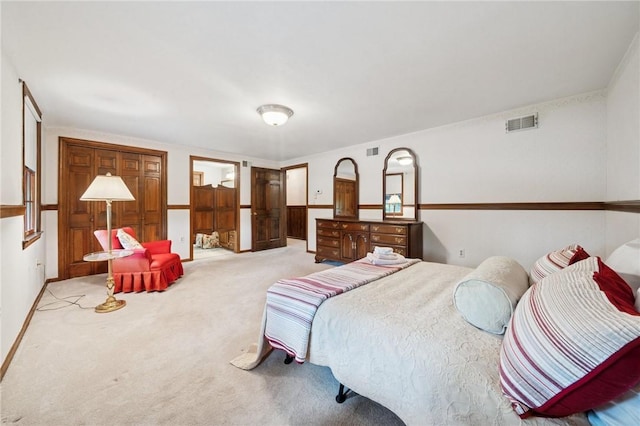 bedroom featuring visible vents and light colored carpet