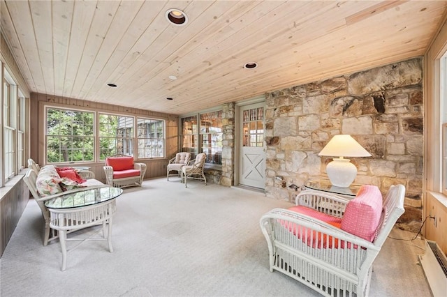 interior space with carpet, a baseboard heating unit, and wooden ceiling
