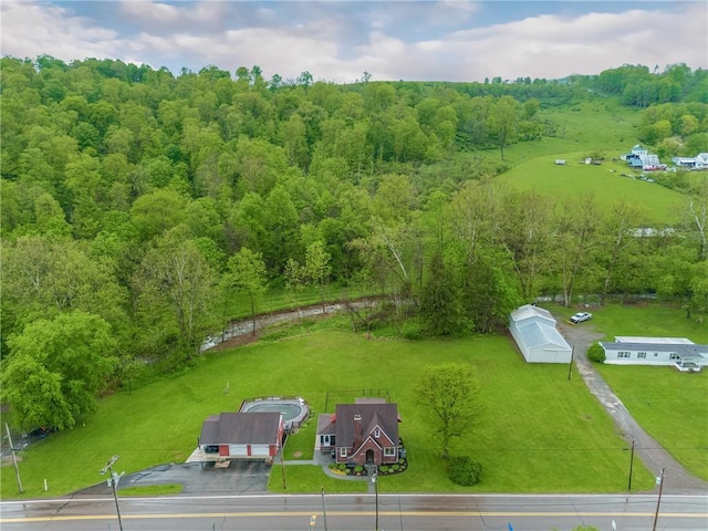 drone / aerial view featuring a wooded view
