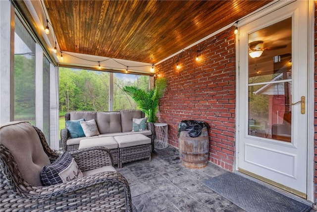 sunroom with ceiling fan, a wealth of natural light, and an outdoor living space