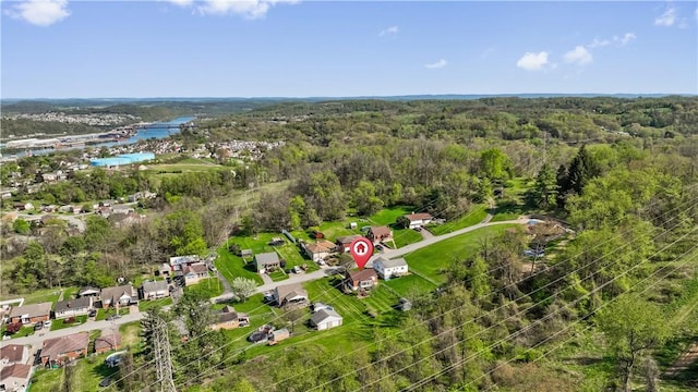 drone / aerial view featuring a forest view and a residential view