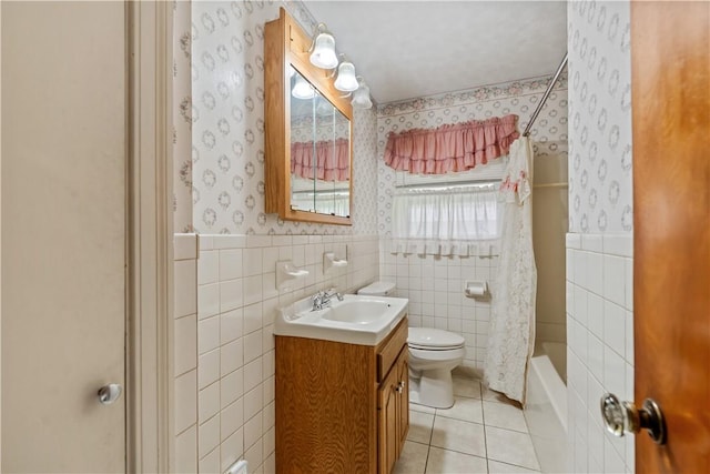bathroom featuring tile walls, wallpapered walls, toilet, tile patterned floors, and vanity