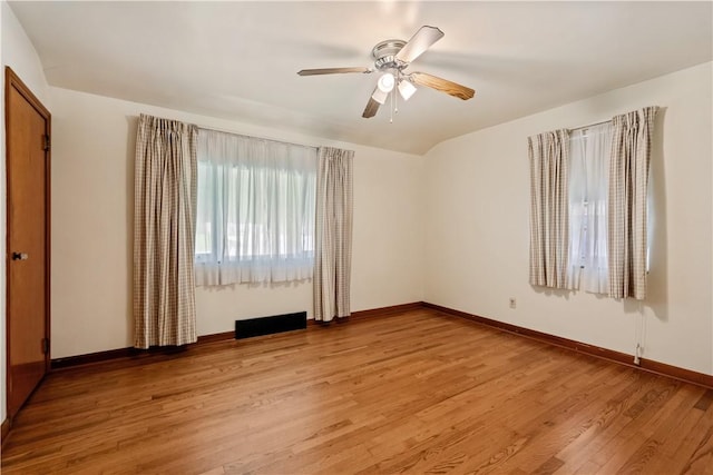 unfurnished room with light wood finished floors, baseboards, and ceiling fan
