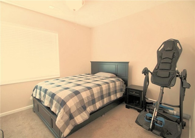 bedroom with light carpet and baseboards